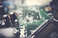 Detailed view of a computer motherboard highlighting capacitors and connections.